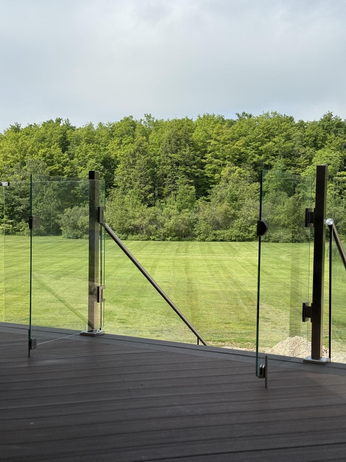 Glass railing with metal posts on composite deck